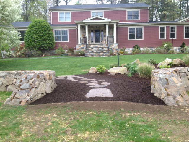 Stone entrance walls and stepping path leading to a Fairfield County home
