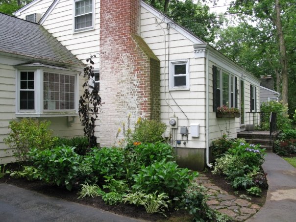Side-yard plantings and stone path along a Connecticut home