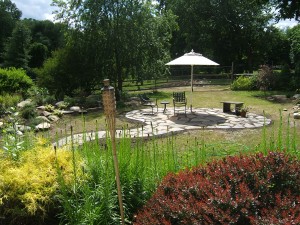 Circular natural stone patio and curvy path.